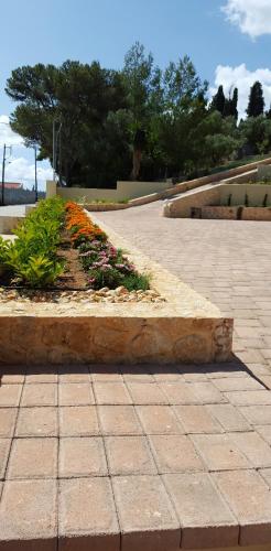 a garden with flowers in the middle of a sidewalk at Ionian Vista Villas in Argostoli