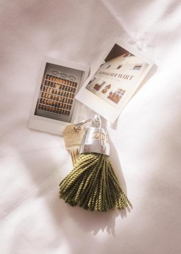 a key chain with a magazine and a book at Romantik Spa Hotel Elixhauser Wirt in Elixhausen