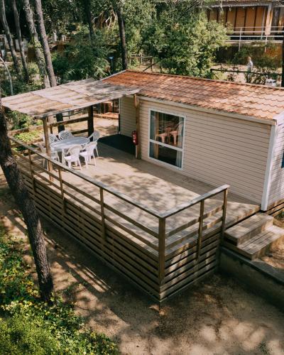 a large wooden deck with a table and chairs on it at Camping Santa Elena in Lloret de Mar