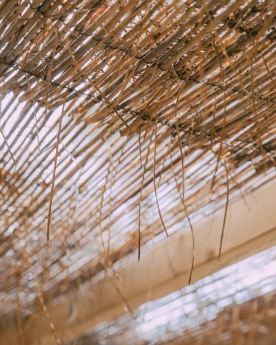 a stack of straw hanging from a roof at Camping Santa Elena in Lloret de Mar