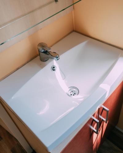 a sink in a small bathroom with a faucet at Camping Santa Elena in Lloret de Mar