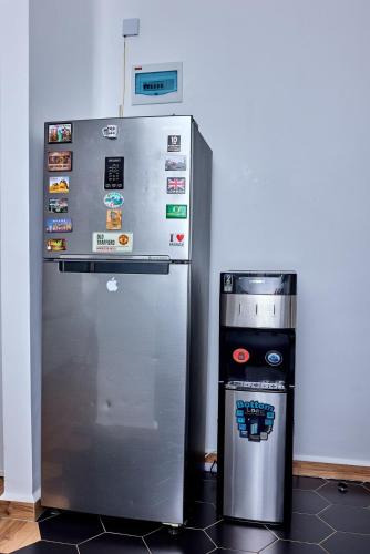 a refrigerator and a trash can in a room at Modern and Luxurious 2 Bedroom in Tatu City