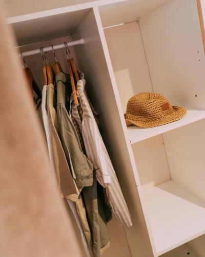 a walk in closet with umbrellas on hooks at Camping Santa Elena in Lloret de Mar