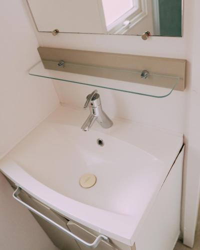 a bathroom sink with a mirror on top of it at Camping Santa Elena in Lloret de Mar
