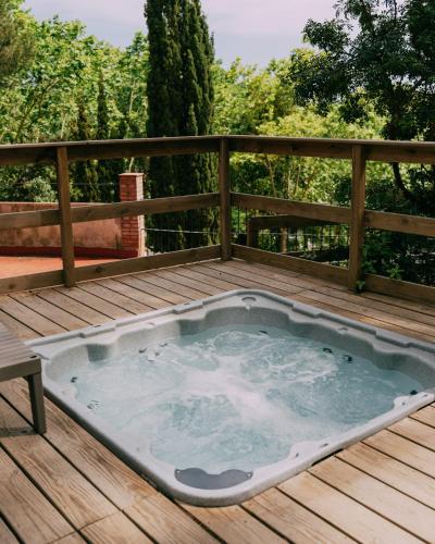 a hot tub on a deck with a fence at Camping Santa Elena in Lloret de Mar