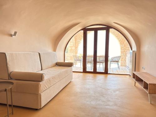 a living room with a couch and a table at Pirgos Petropoulea in Poliána