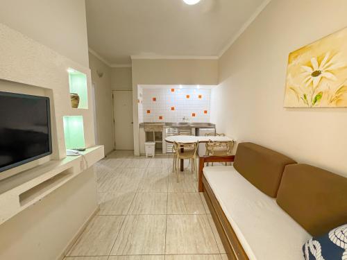 a living room with a couch and a table at Hotel Nacional Inn Guarujá in Guarujá