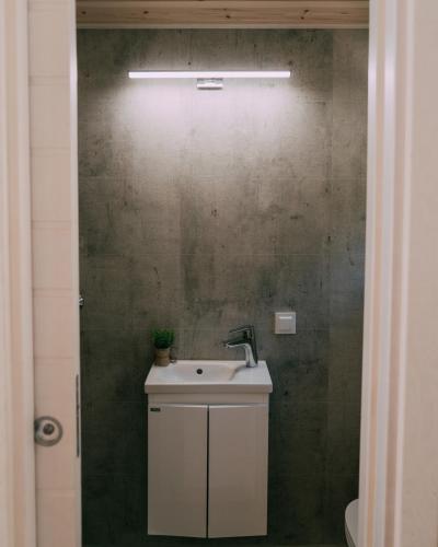 a bathroom with a sink and a green wall at Camping Santa Elena in Lloret de Mar