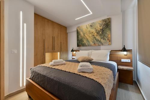 a bedroom with a large bed with two towels on it at September15 Suites- Meganisi in Meganisi