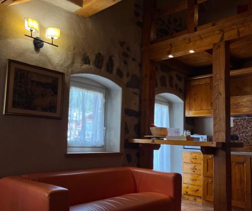 a living room with a couch and a kitchen at Castel Madonna in San Martino di Castrozza