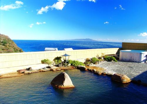 a large rock in the middle of a body of water at LiVEMAX Resort Izu Okawa in Higashiizu