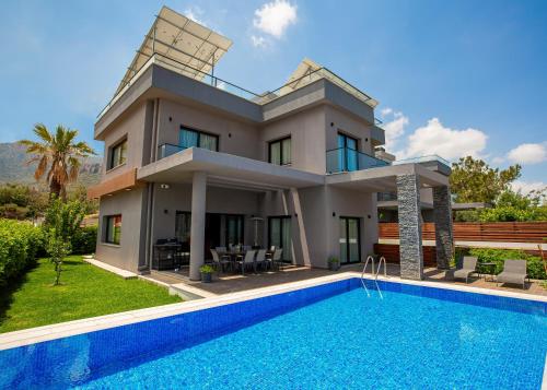 una villa con piscina frente a una casa en Maestral Mansion, en Kyrenia