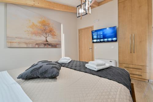 a bedroom with a bed with two towels on it at September15 Suites- Meganisi in Meganisi