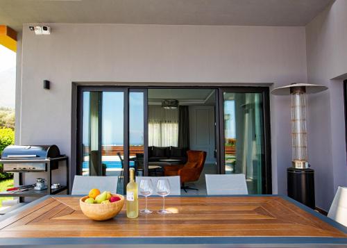 una mesa de comedor con un tazón de frutas y copas de vino en Maestral Mansion, en Kyrenia