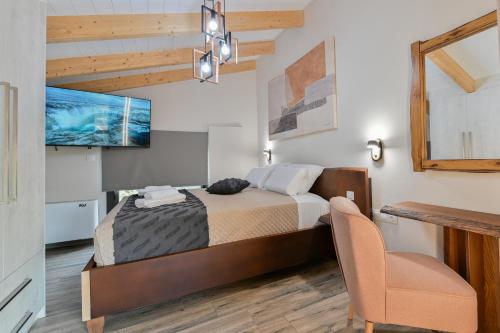 a bedroom with a bed and a chair at September15 Suites- Meganisi in Meganisi