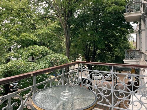 a glass table sitting on top of a balcony at Continental Hotel in Odesa