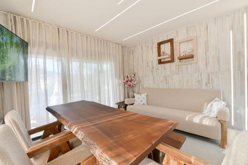 a living room with a wooden table and a couch at September15 Suites- Meganisi in Meganisi