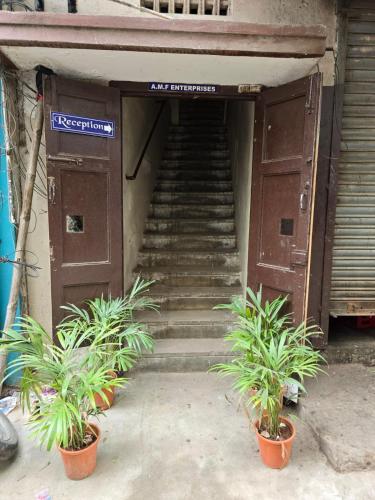 a staircase leading up to a building with potted plants at Marhaba Guest House - Budget in Chennai