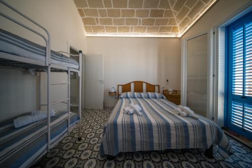 a bedroom with a bed with two bunk beds at The twins Rooms in Marettimo 2 in Marettimo