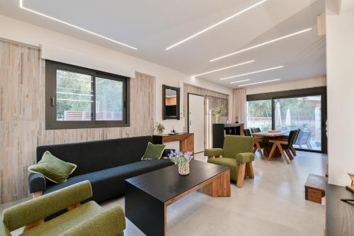 a living room with a couch and a table at September15 Suites- Meganisi in Meganisi
