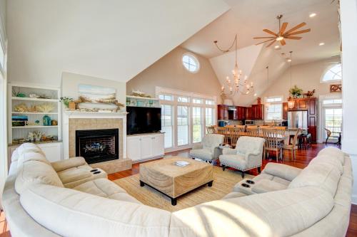 a living room with a large couch and a fireplace at Footprints in North Topsail Beach