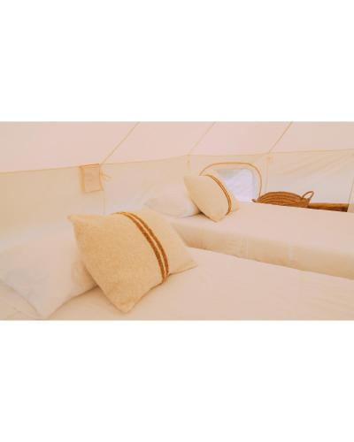 two beds with pillows on them in a room at Camping Santa Elena in Lloret de Mar