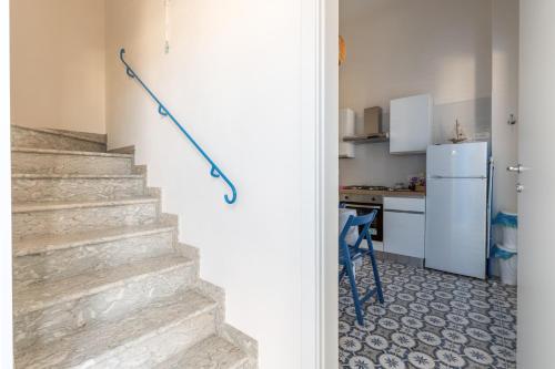 a stairway with a blue rope in a kitchen at The twins Rooms in Marettimo 2 in Marettimo