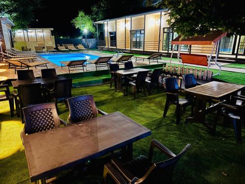 a group of tables and chairs next to a swimming pool at 13th Turn in Borjomi