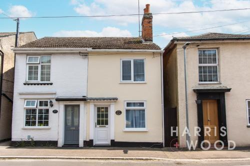a white house with a sign that reads harris wood at Saltmarsh Cottage in Brightlingsea