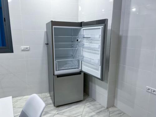 a refrigerator with its door open in a kitchen at Appartement Alhoceima in Imejoudene