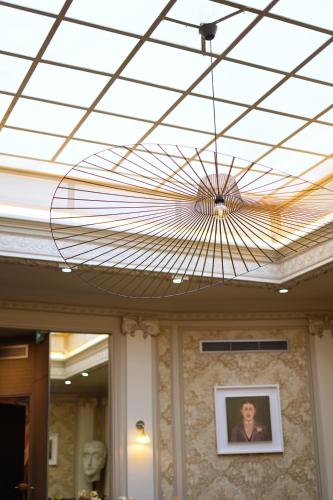 a chandelier hanging from the ceiling of a building at Hotel Litteraire Le Swann, BW Premier Collection in Paris