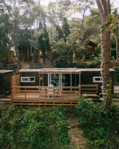 a house with a deck with a train at Camping Santa Elena in Lloret de Mar