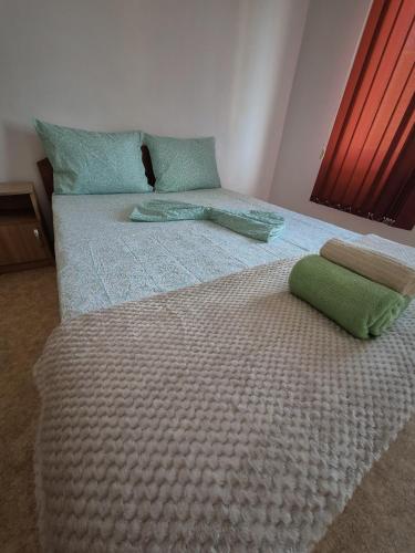 a bed with two pillows on top of it at Vila Republicii - Eforie Nord Centru in Eforie Nord