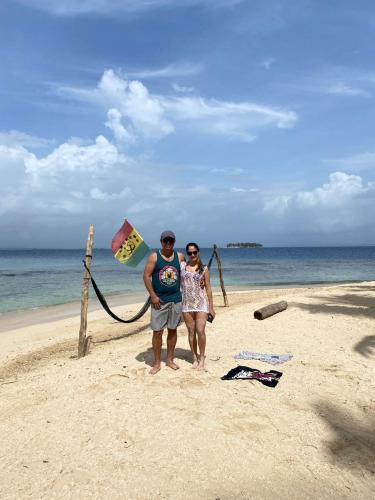 two people standing on a beach with a kite at Room on Barco Hundido Island in Panama City
