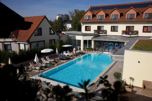 a large swimming pool in front of a building at Hotel Zum Stein Wellness & Genuss Resort in Oranienbaum-Wörlitz