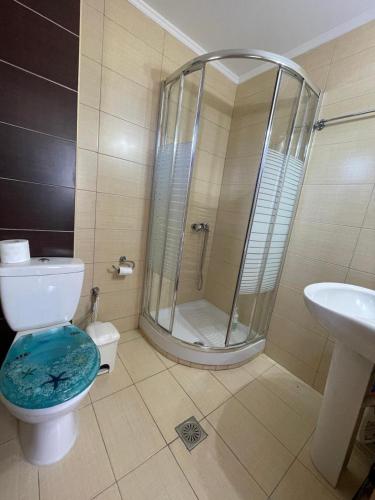a bathroom with a shower and a toilet and a sink at Dream House in Nea Roda