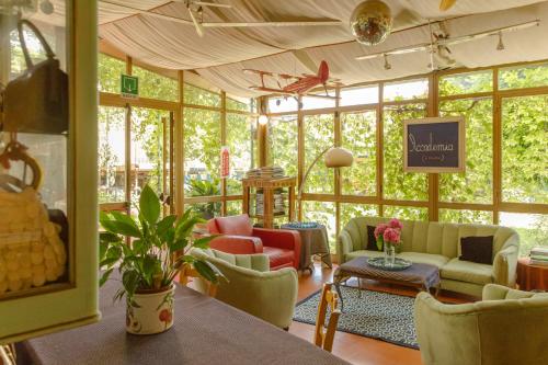 a conservatory with chairs and tables in a room at Albergo La Felicina - Mugello in San Piero a Sieve