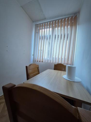 a table and chairs in a room with a window at Vila Republicii - Eforie Nord Centru in Eforie Nord