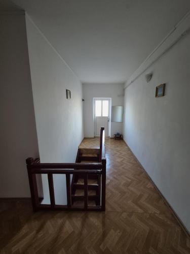 an empty room with a table and a chair at Vila Republicii - Eforie Nord Centru in Eforie Nord