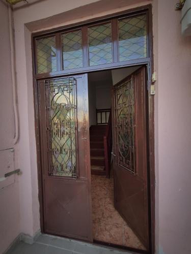 an entrance to a room with two doors with stained glass at Vila Republicii - Eforie Nord Centru in Eforie Nord