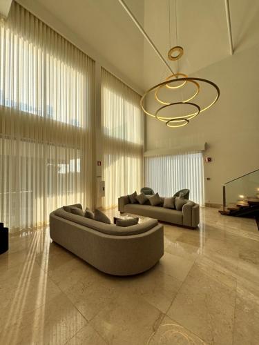 a living room with two couches and a chandelier at Quinta da Maquia Hotel in Sintra