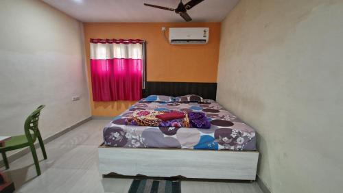 a bedroom with a bed in a room at Aditya Inn in Gopālpur