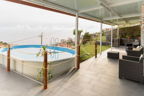 a hot tub on a house with a view at Casa do Vale by Mth in Ribeira Brava