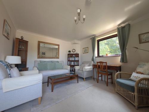 a living room with a couch and a table at 19 Seaview Bay - Charming Seafront Apartment on the Isle of Wight in Seaview