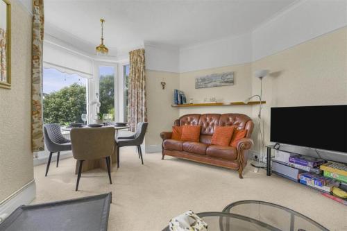 a living room with a couch and a table at Sea View Home in lovely Ogmore-by-Sea in Tythegston