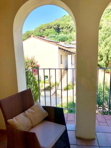 a room with a table and a view of a balcony at Hotel Santo Stefano in Portoferraio