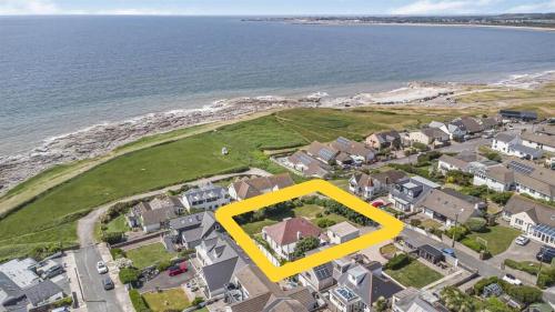an aerial view of a house with a yellow box at Sea View Home in lovely Ogmore-by-Sea in Tythegston