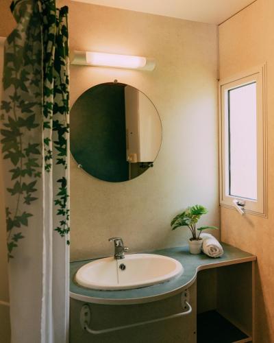 a bathroom with a sink and a mirror at Camping Santa Elena in Lloret de Mar