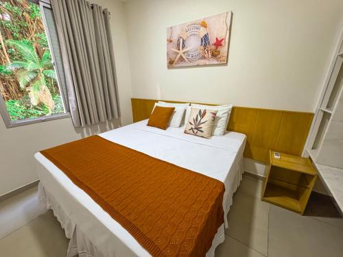 a bedroom with a bed in a room at Hotel Nacional Inn Guarujá in Guarujá