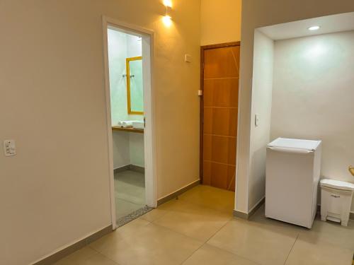 a bathroom with a toilet and a sink and a mirror at Hotel Nacional Inn Guarujá in Guarujá